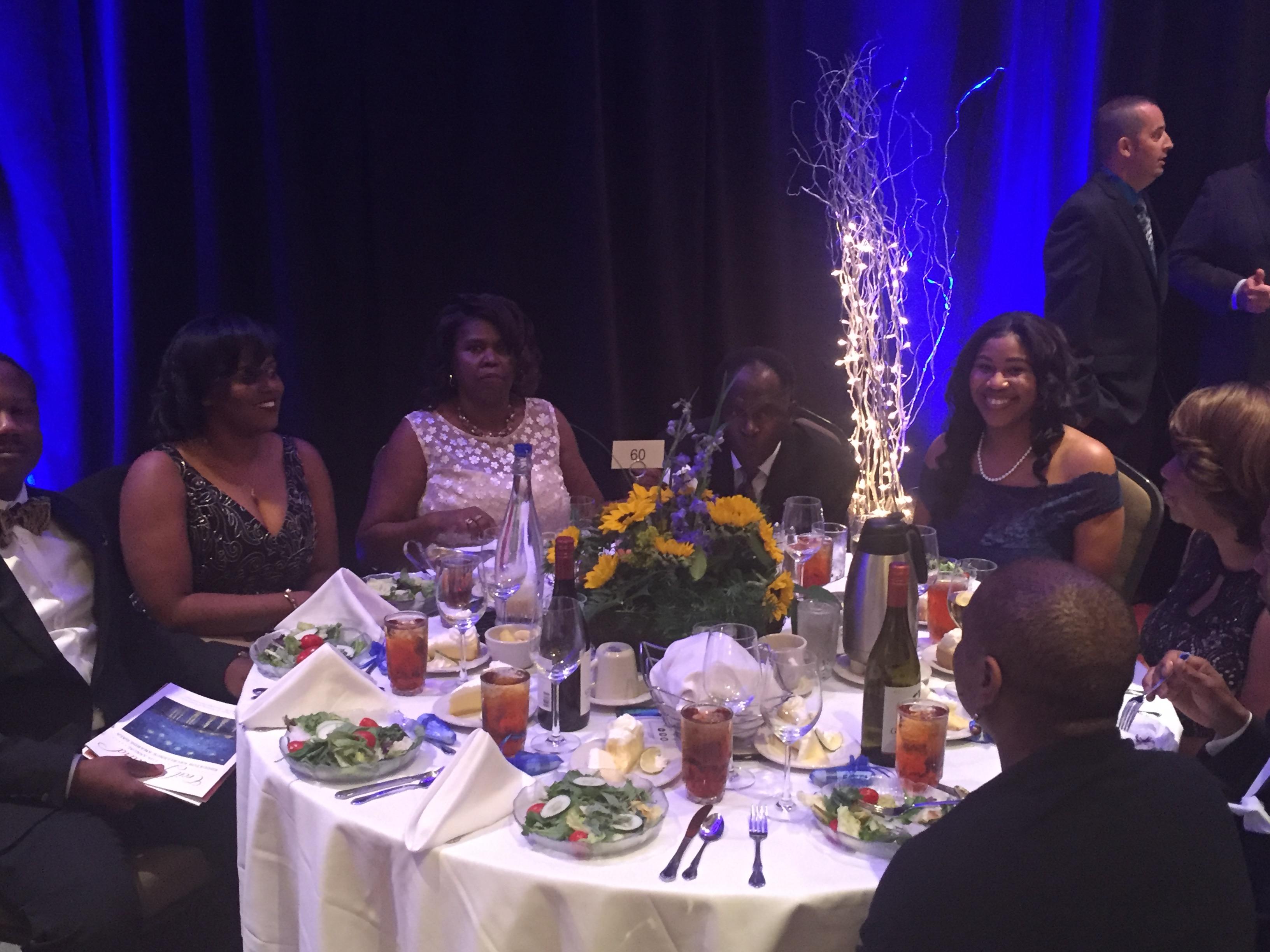 Photo of Principal Penn and table of invited guests at the state sponsored gala honoring educators from across the state
