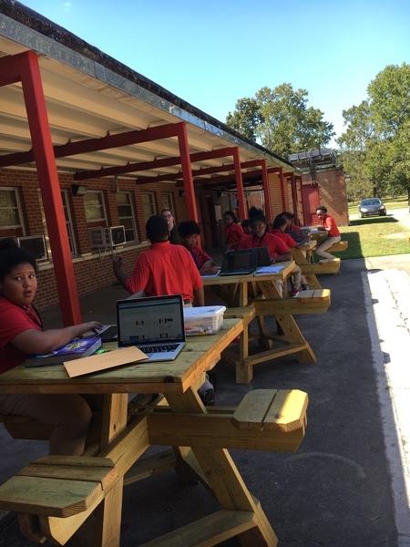 A photo of Baker Middle School Students learning outdoors in a natural environment