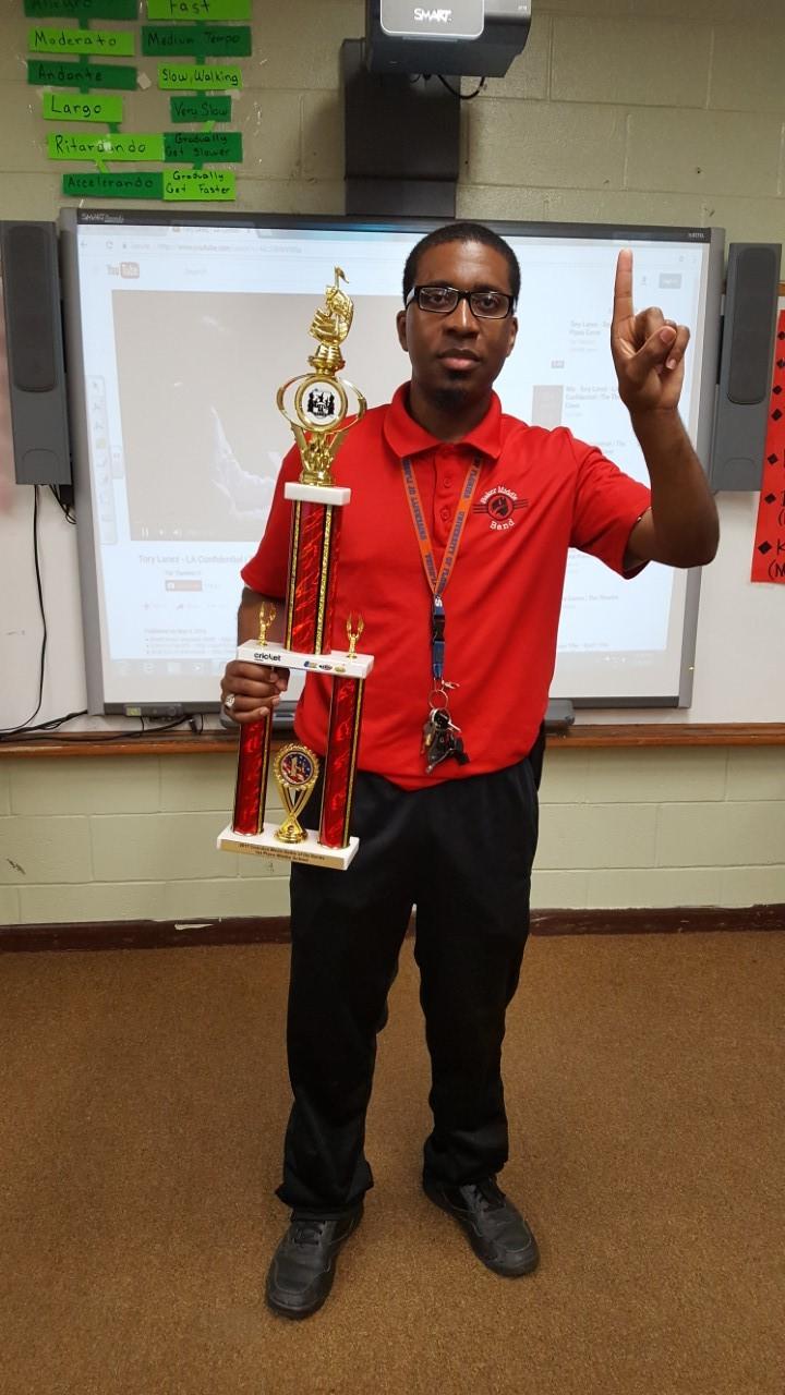  Baker Middle Band Students hold winning trophy from battle of the bands