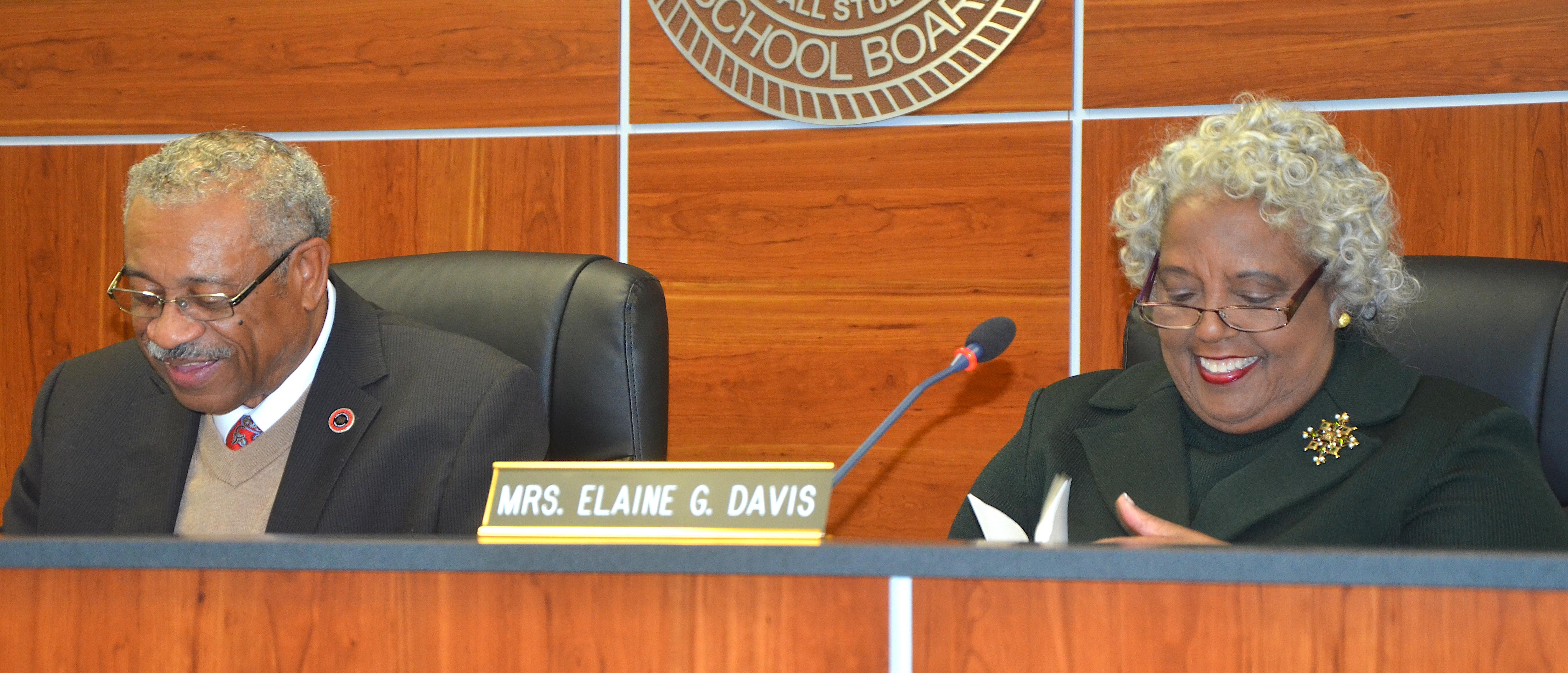 Photo of new Baker School Board Chairman, Dr. Dana Carpenter, and Elaine Davis sharing a laugh at board meeting