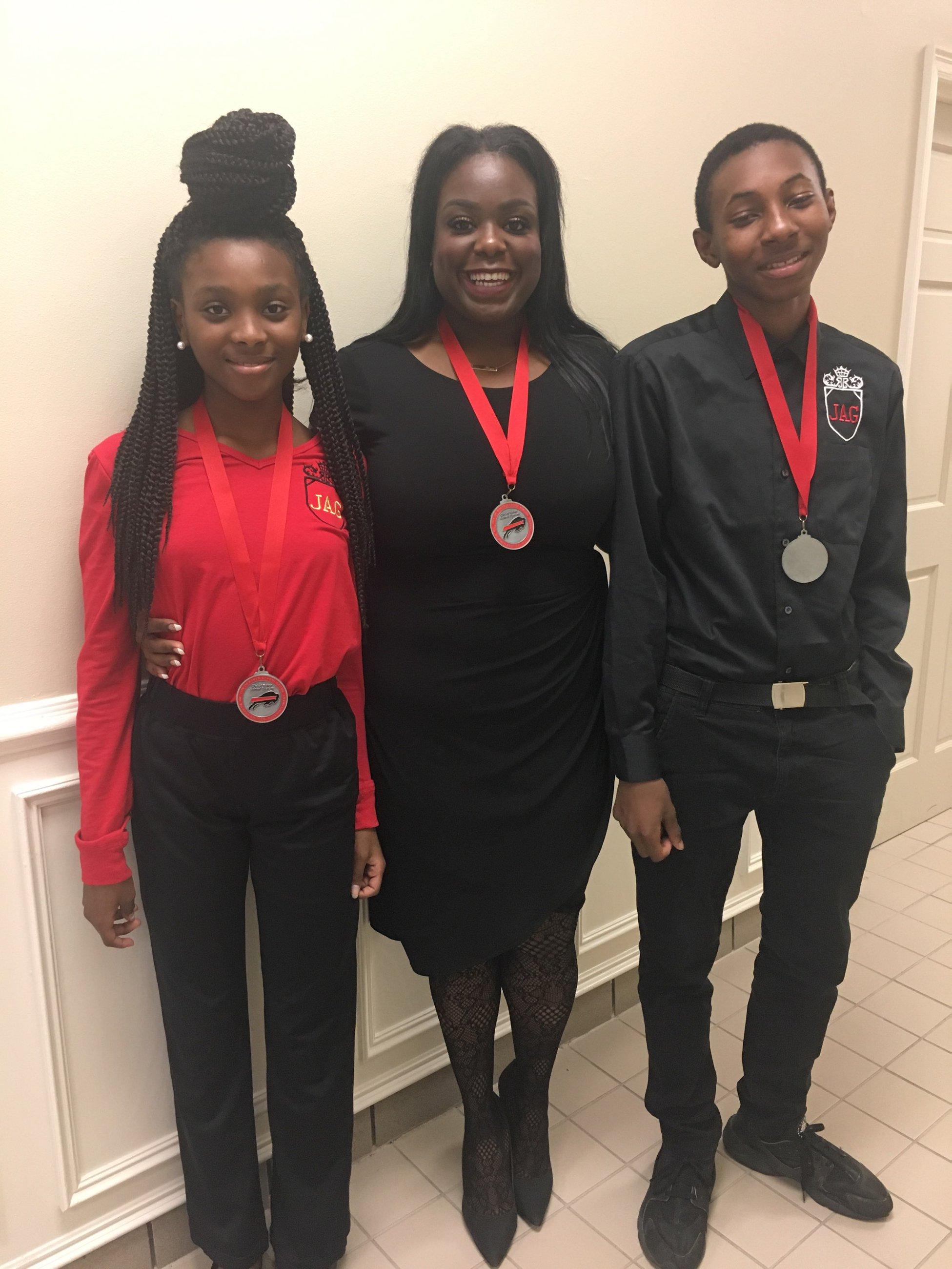 A photo of Baker Middle JAG students and teacher awarded district medallions