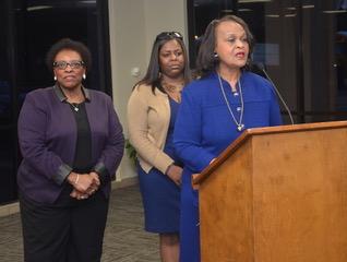Photo of three Southern University employees addressing the City of Baker School Board to discuss a proposed agreement