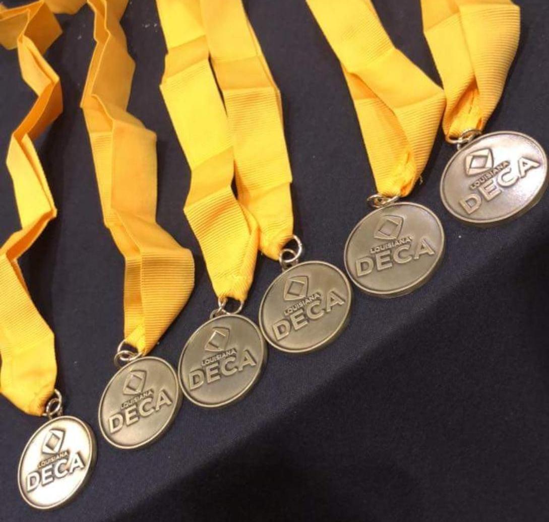 a photo of the 1st place medals the Baker High School DECA students won