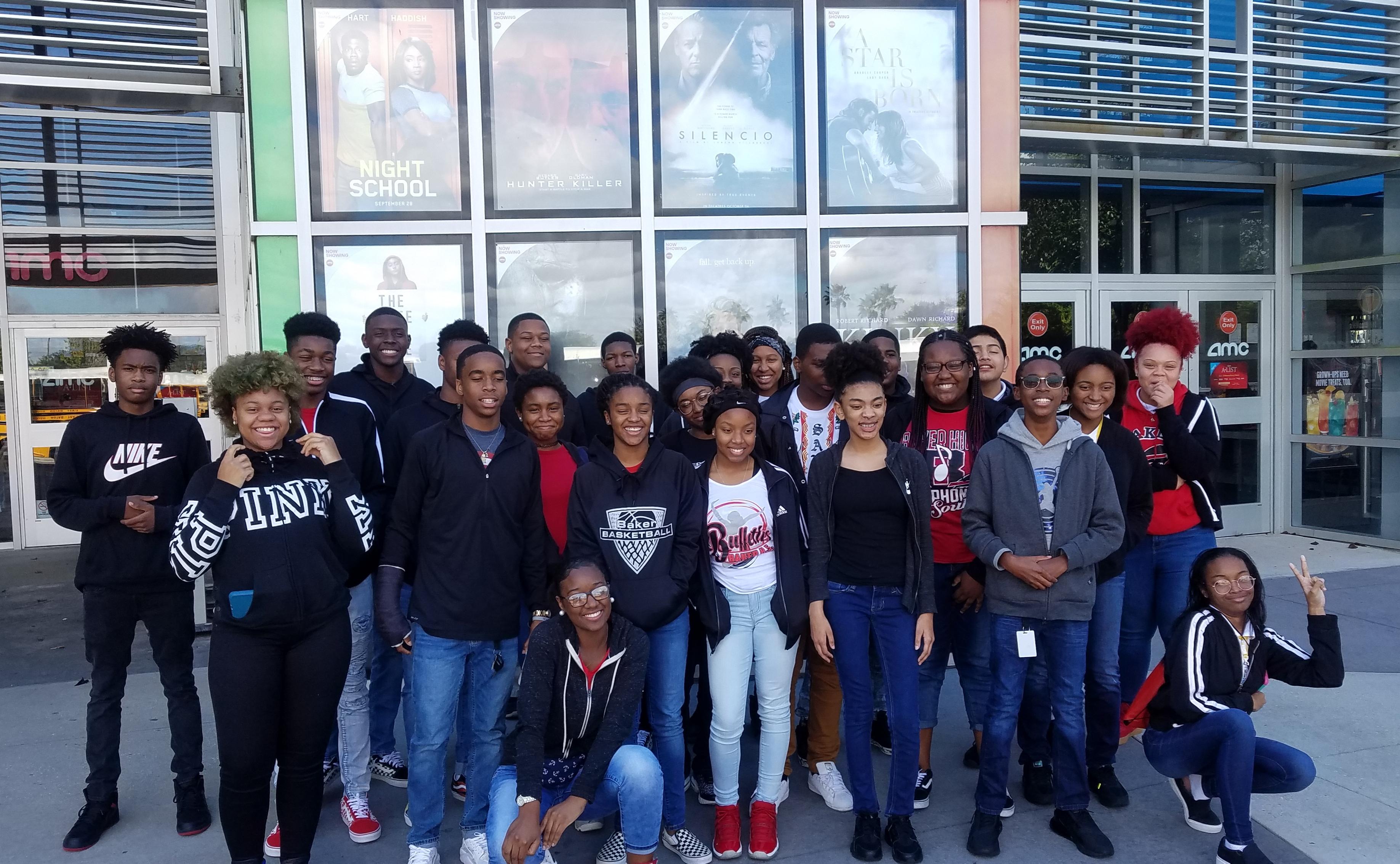 a group photo of Baker High 9th graders in front of AMC Theaters on school field trip to see movie