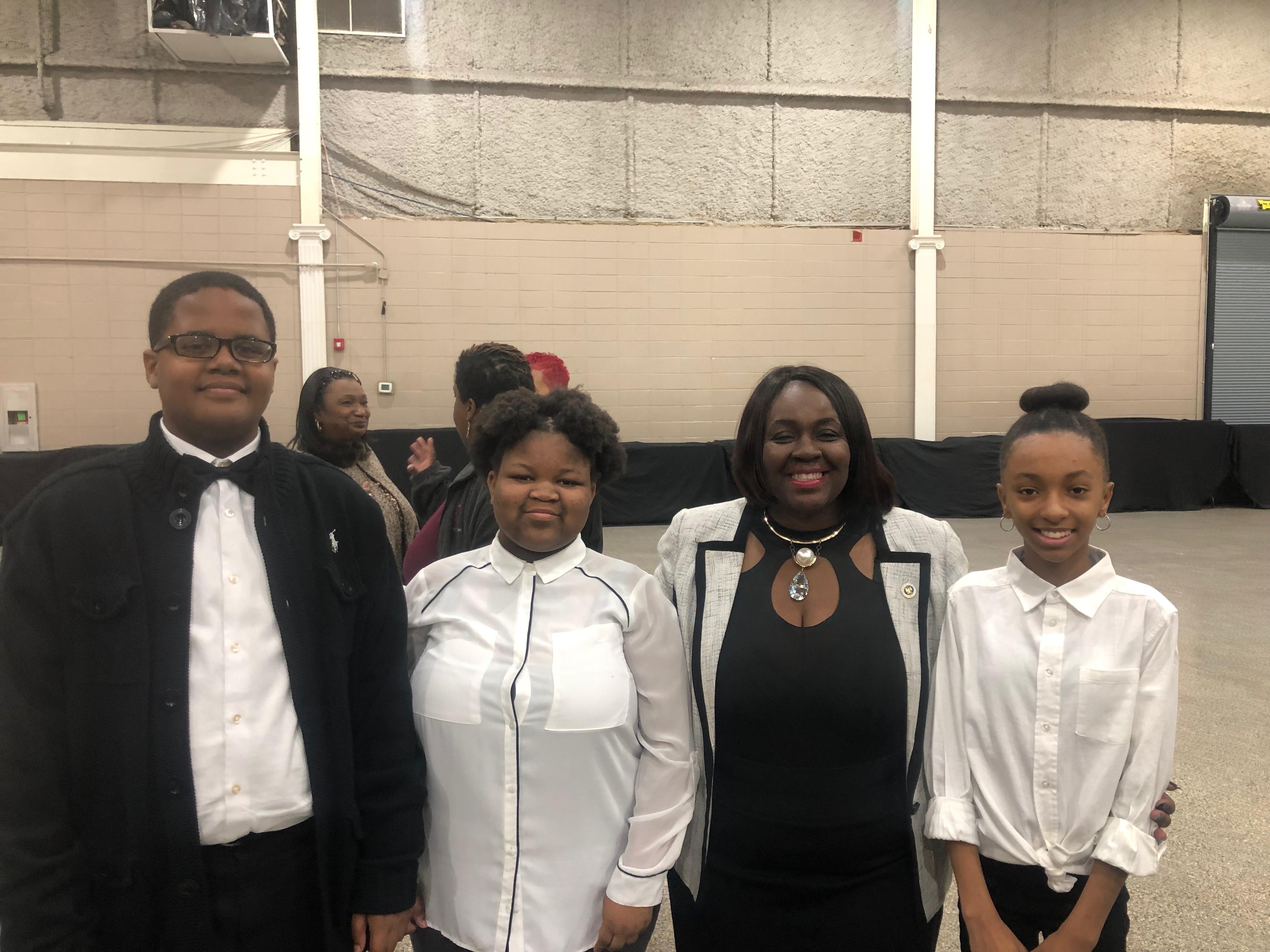 Photo of the Baker Middle School Choral Ensemble with State Representative Regina Barrow