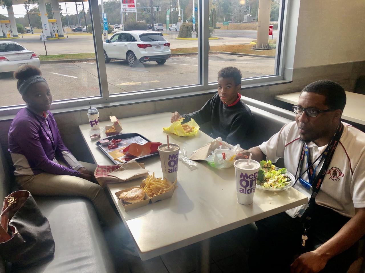 A photo of Baker Middle School's November teacher and students of the month having a complimentary meal at McDonald's