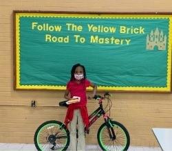 a photo of a your girl who won a bicycle for learning challenge